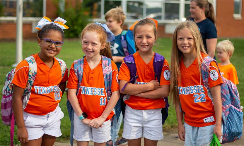 A group of elementary students smile